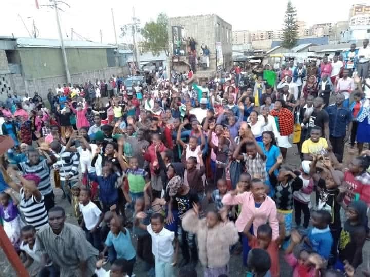 A large outdoor gathering of children and families