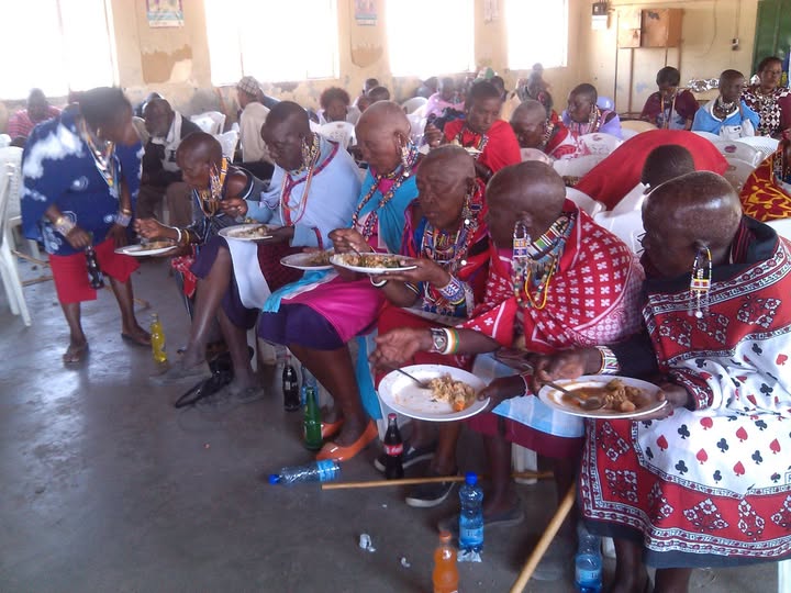 Elderly community members sharing a meal together indoors