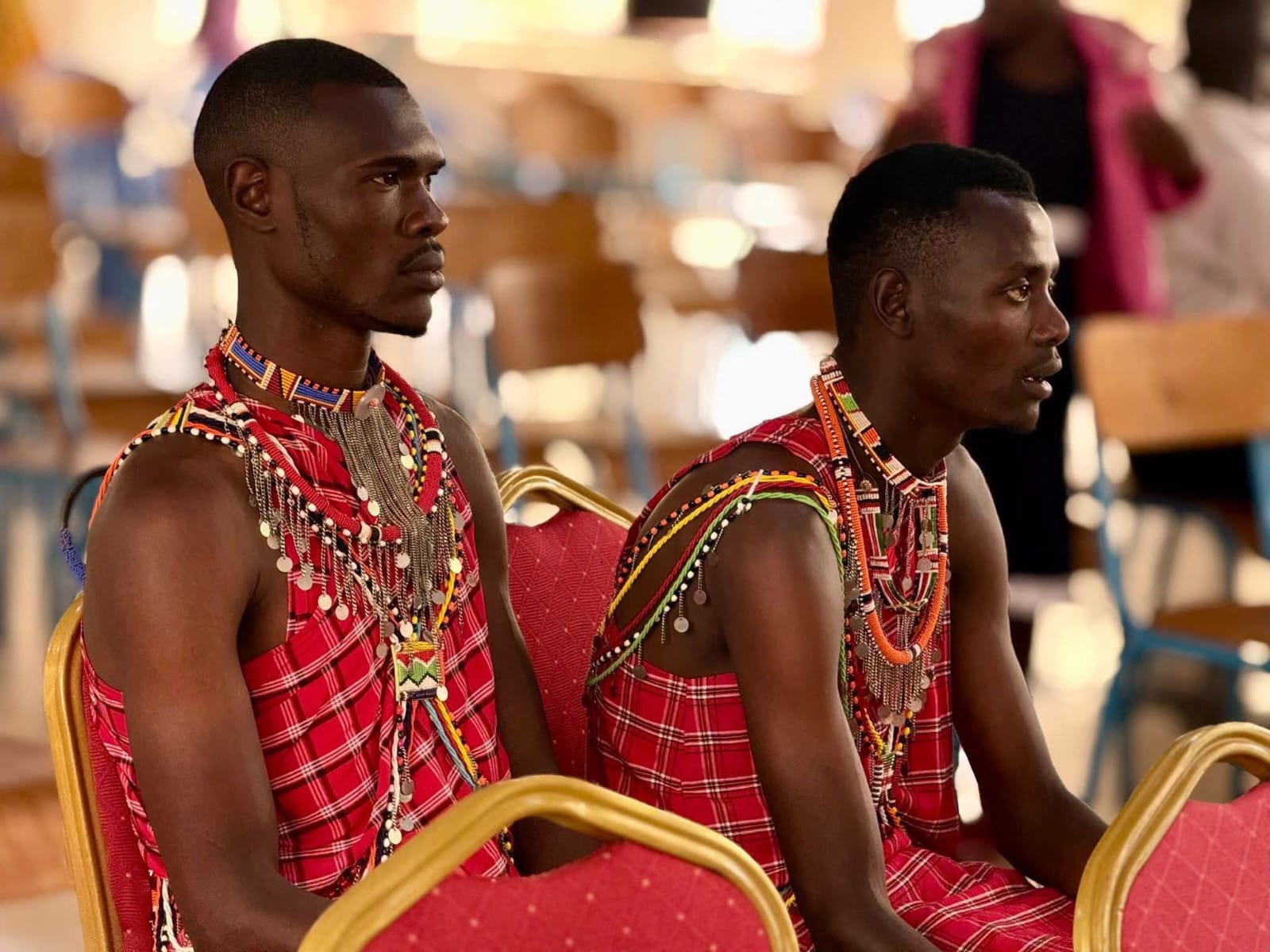 Community leaders in traditional dress seated together during a gathering