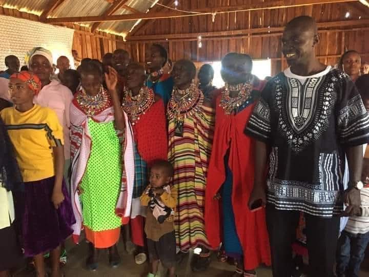 Women and children gathered inside a community hall